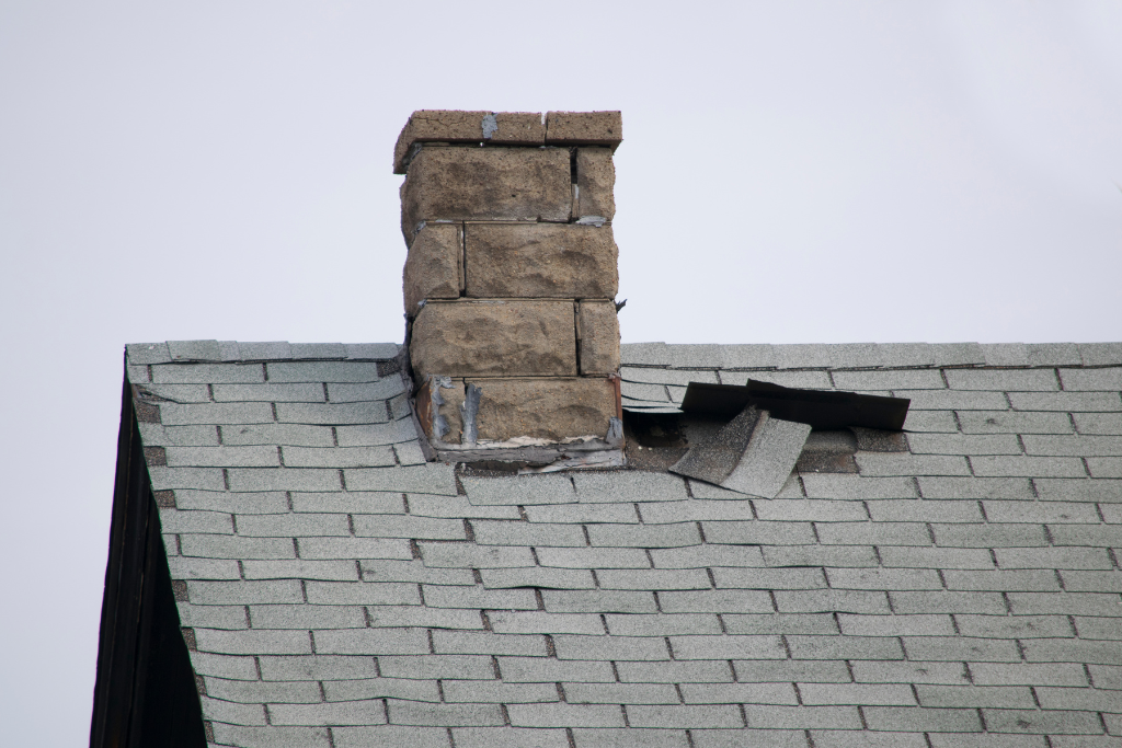 broken shingles and damaged roof in need of winter attic maintenance